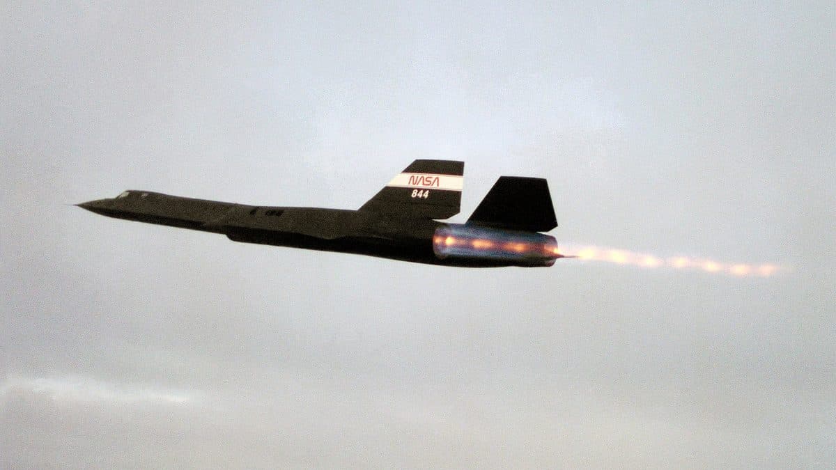 SR-71 Blackbird in flight at high altitude showing its dark titanium airframe against the curvature of the earth