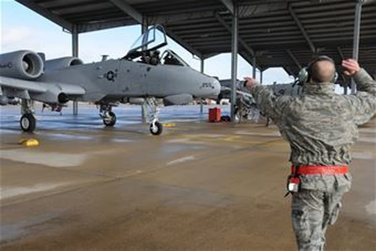 A-10 Thunderbolt II in flight, showing its distinctive twin-engine, straight-wing profile against a clear sky