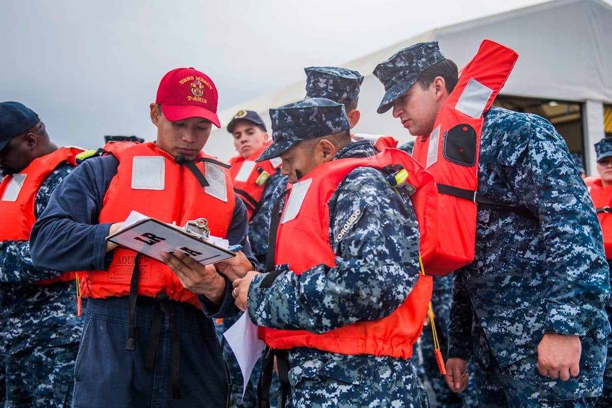 An abandoned military base with weathered buildings and overgrown grounds