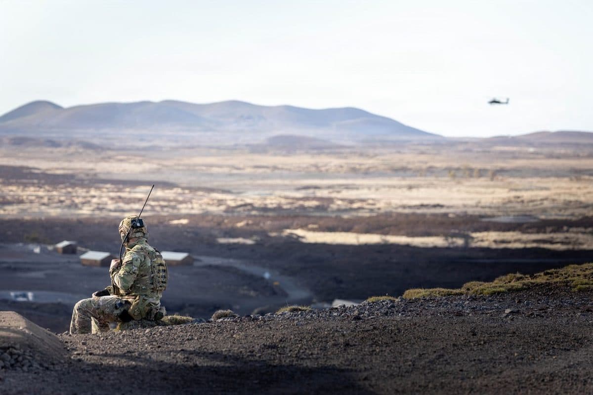AH-64 Apache helicopter firing rockets during a live-fire exercise