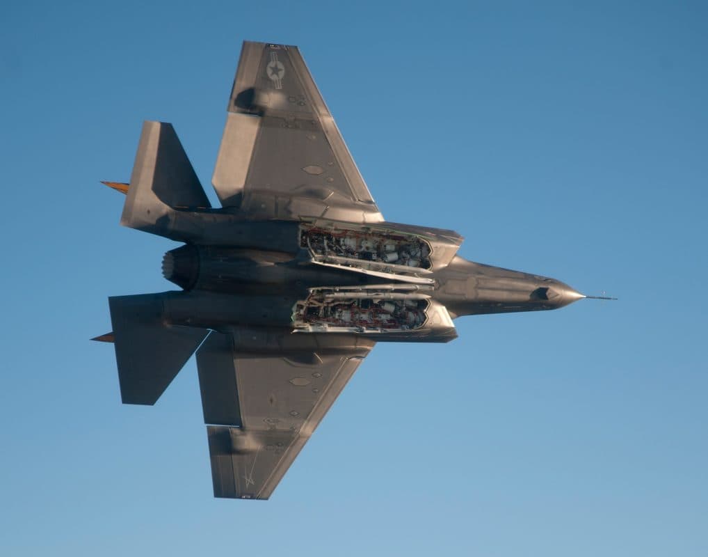 F-35 Lightning II with internal weapons bay doors open, revealing missile stations designed for beyond-visual-range air-to-air missiles