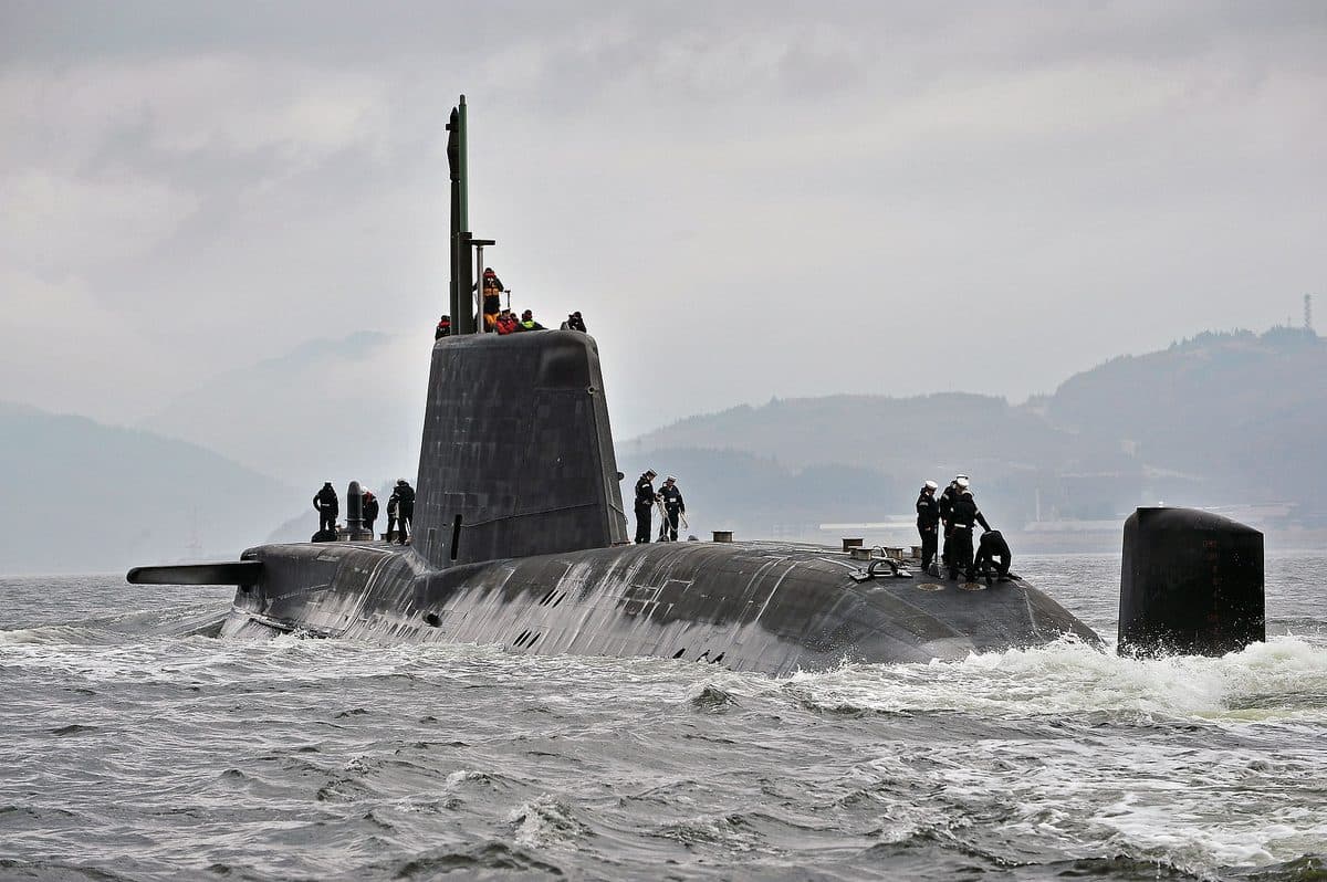 HMS Astute nuclear-powered attack submarine surfacing in open water showing its sleek hull design