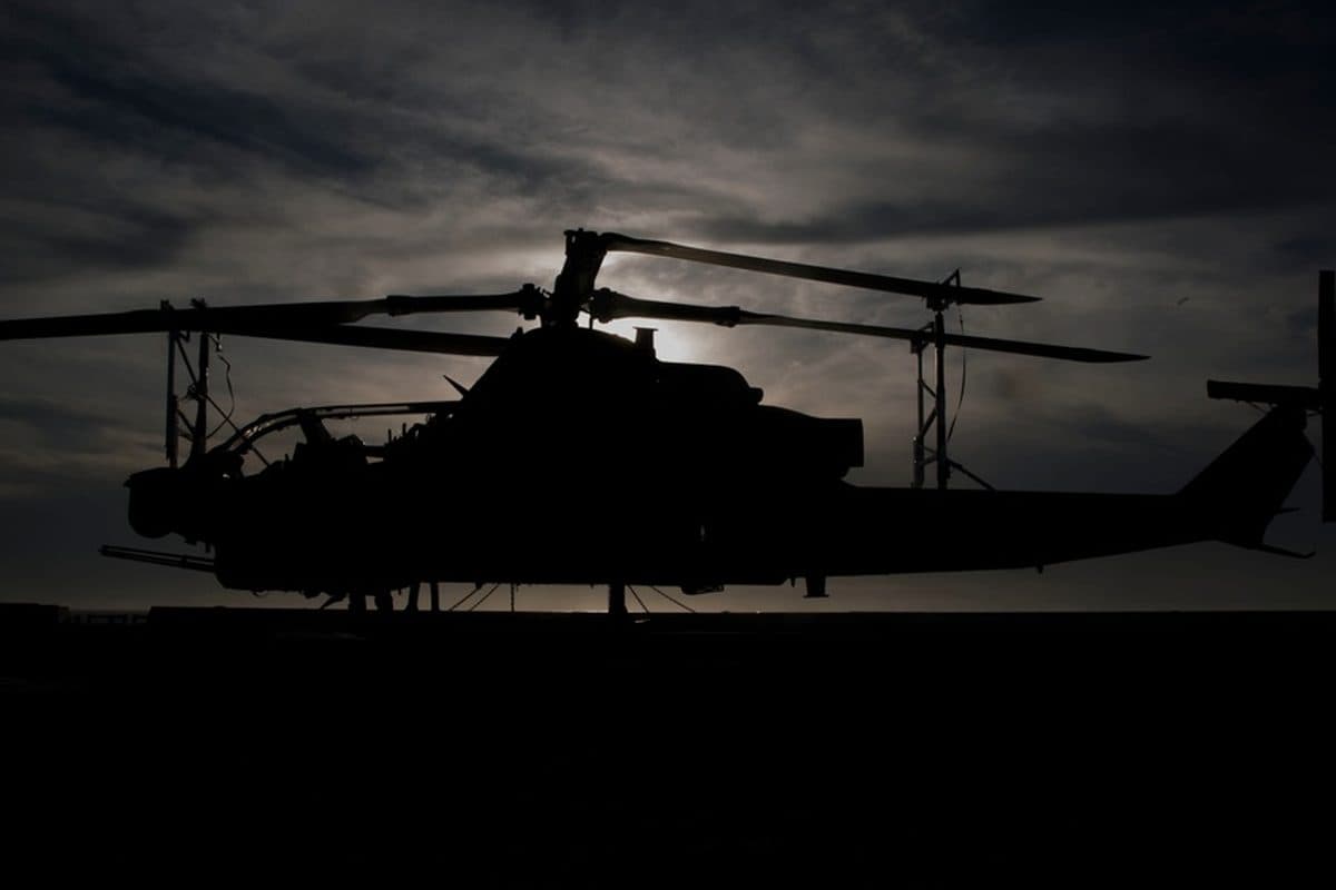 Bell AH-1Z Viper attack helicopter in flight over open terrain