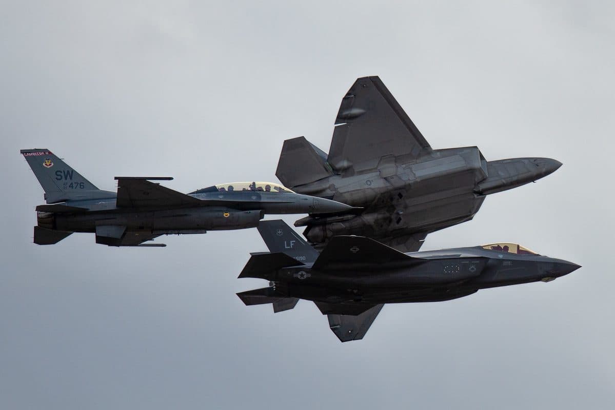F-22 Raptor in flight over mountains