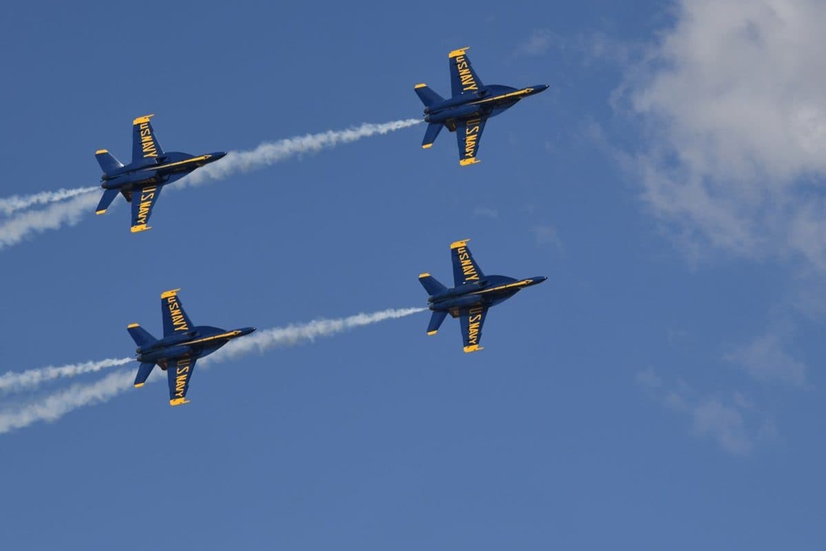 Blue Angels aerobatic team flying in tight diamond formation