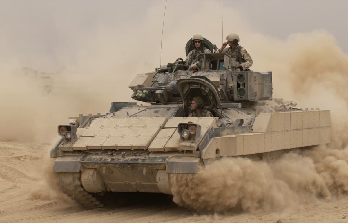 M2 Bradley infantry fighting vehicle advancing across open terrain during a US Army combined arms exercise