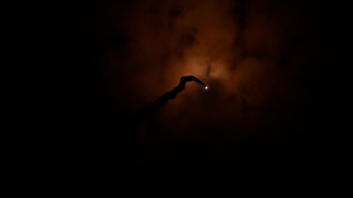 Minuteman III ICBM launching from its silo at Vandenberg Air Force Base with a trail of flame and smoke against a dark sky