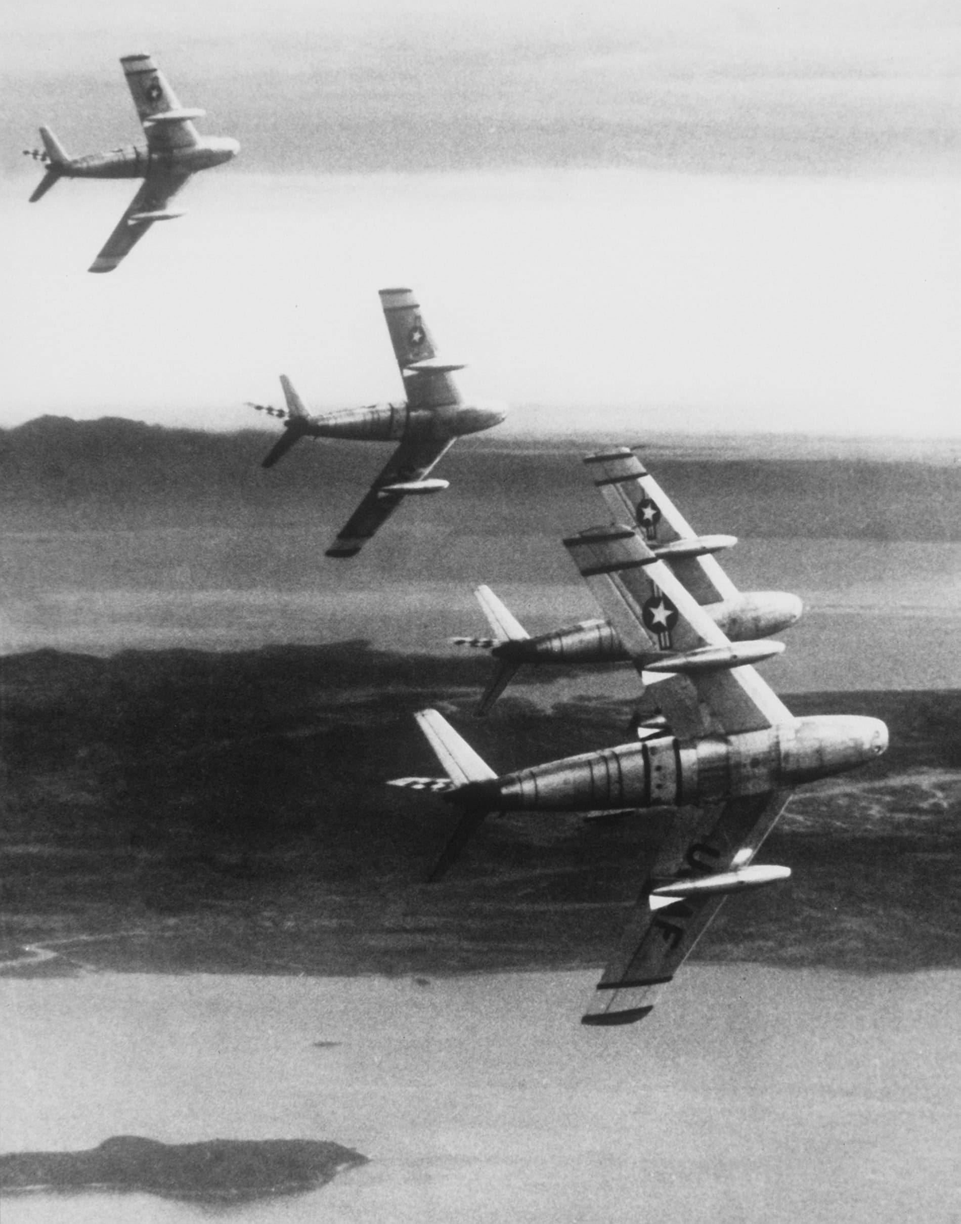F-86 Sabre jet fighter in flight over Korea showing its swept wings and distinctive intake
