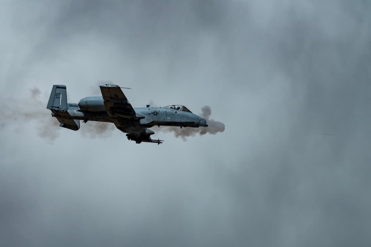 A-10 Thunderbolt II firing its GAU-8 Avenger cannon with gun smoke streaming from the nose