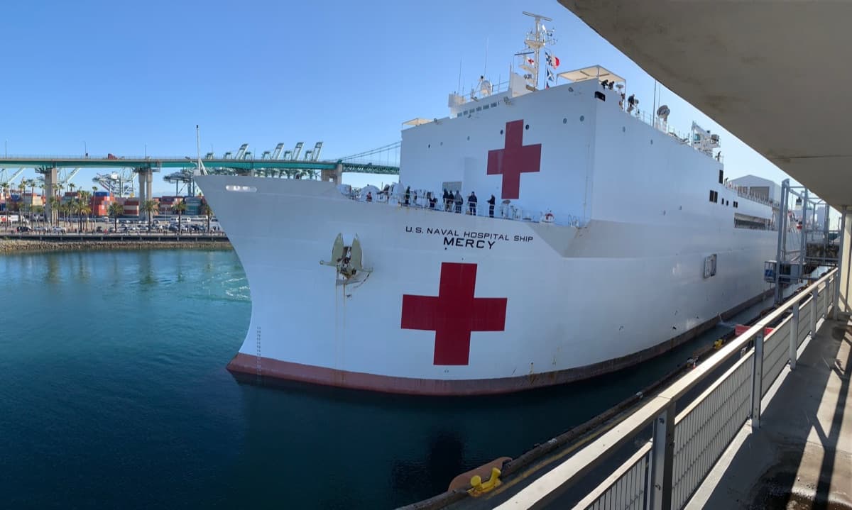 USNS Mercy hospital ship underway during operations, showing the distinctive white hull and red cross markings