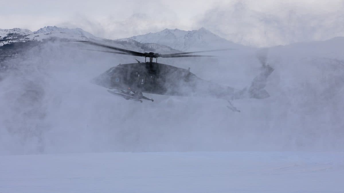 Formation of military helicopters in flight representing multiple generations of rotary-wing combat aircraft