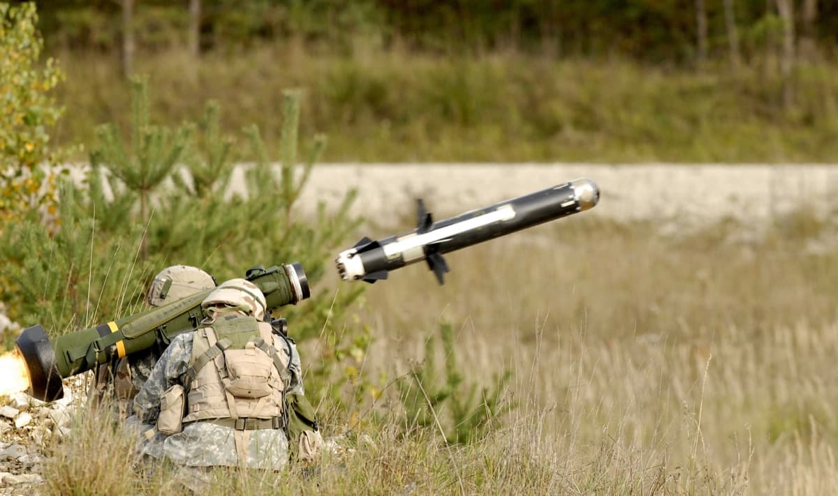 Soldier firing an FGM-148 Javelin anti-tank missile during a live-fire training exercise, with the missile's exhaust visible at launch