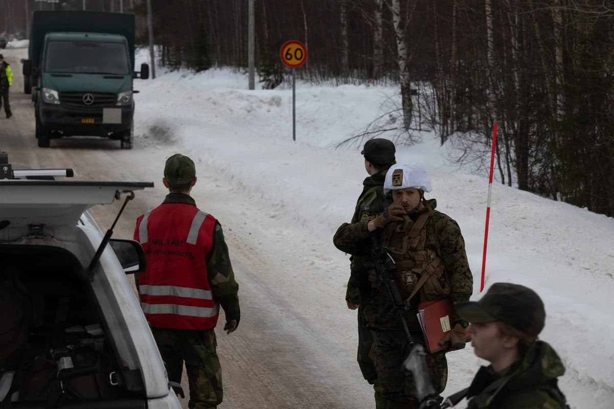 U.S. Marines use a Norwegian cargo ship to transport military equipment for an Arctic exercise, demonstrating modern military logistics