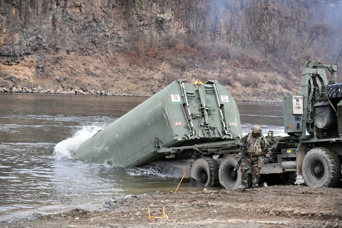 U.S. Army soldiers constructing an Improved Ribbon Bridge across a river during a joint training exercise in South Korea