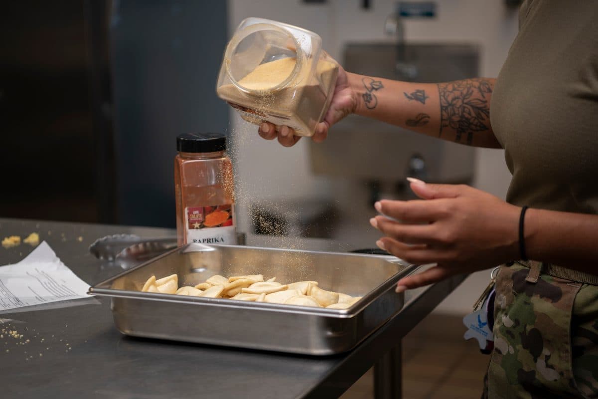 U.S. Army culinary specialists preparing food in a field kitchen during a military exercise