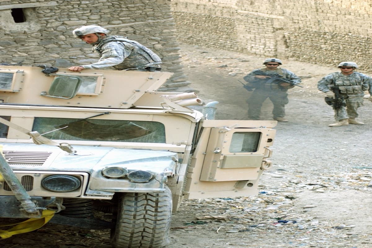 Oshkosh L-ATV military vehicle driving through rugged terrain