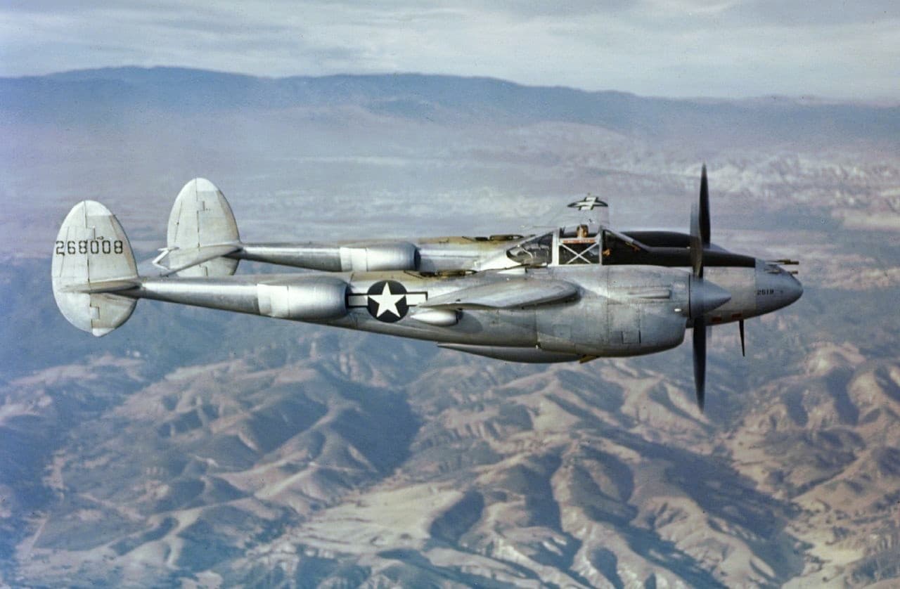 P-38 Lightning fighter aircraft in flight showing its distinctive twin-boom twin-engine design