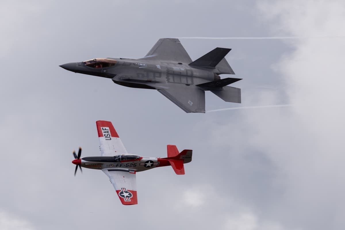 P-51 Mustang flying in formation with an F-35A Lightning II during a heritage flight