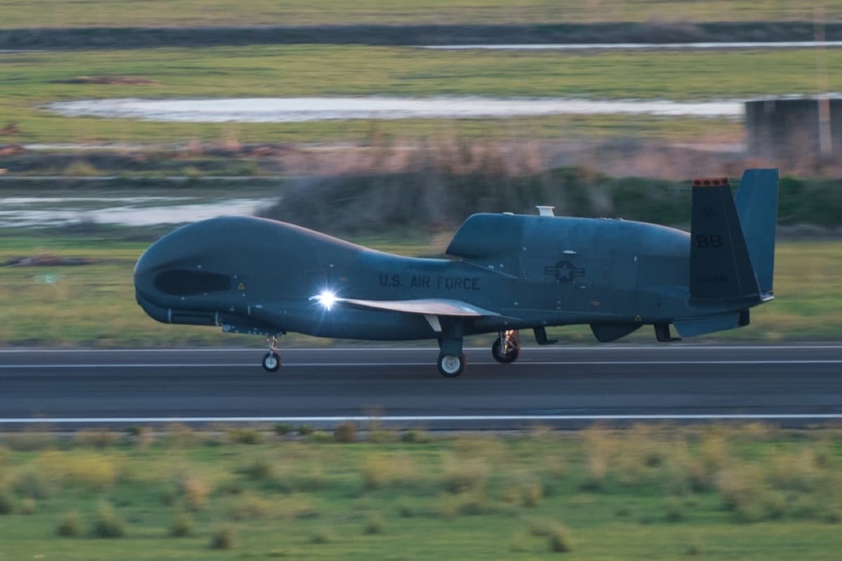 An RQ-4 Global Hawk unmanned aircraft speeding down the runway for takeoff