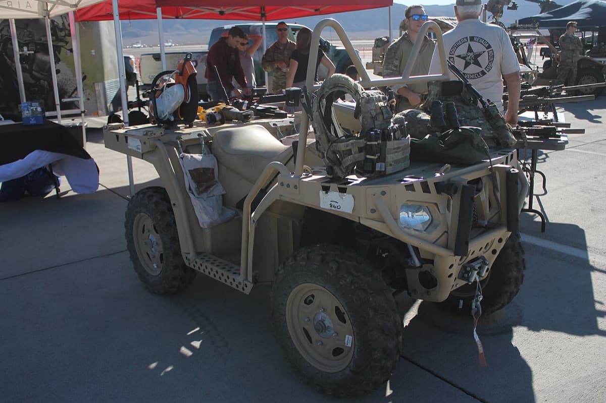 Marine Raiders loading a Polaris MRZR ultra-light tactical vehicle onto a V-22 Osprey during a special operations exercise
