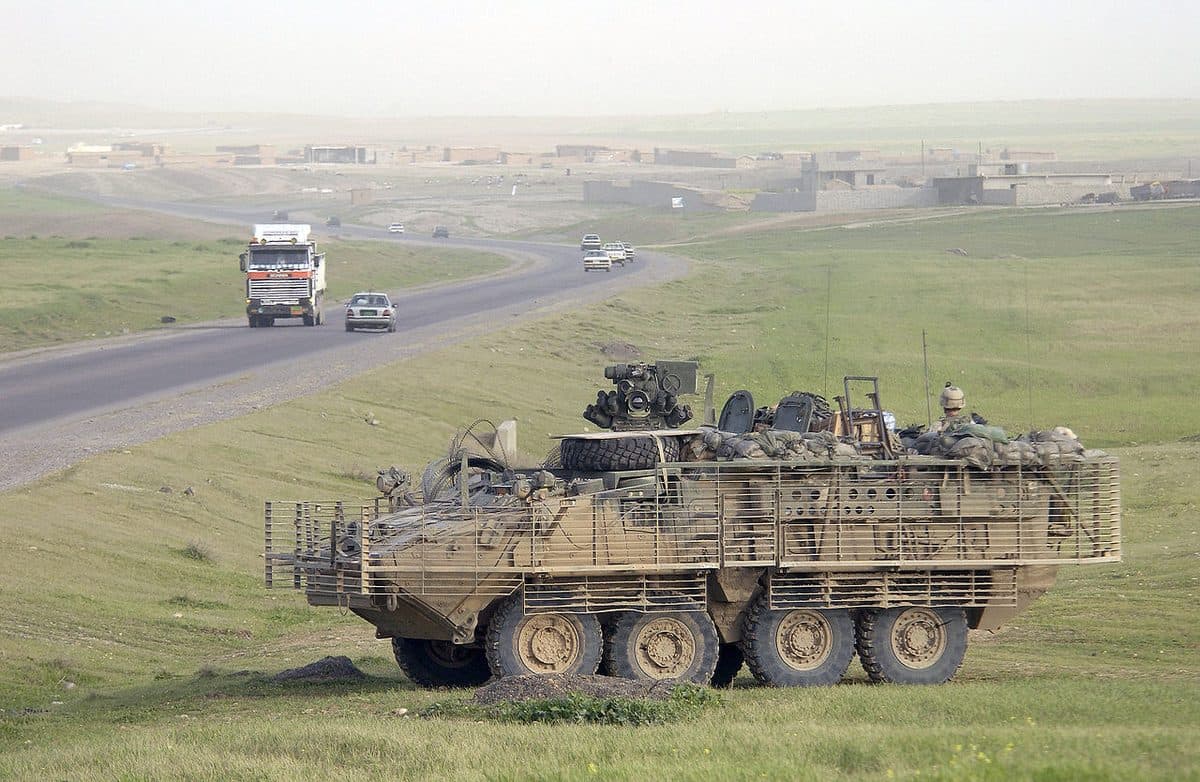 U.S. Army Stryker infantry carrier vehicles on patrol in Iraq with slat armor cages