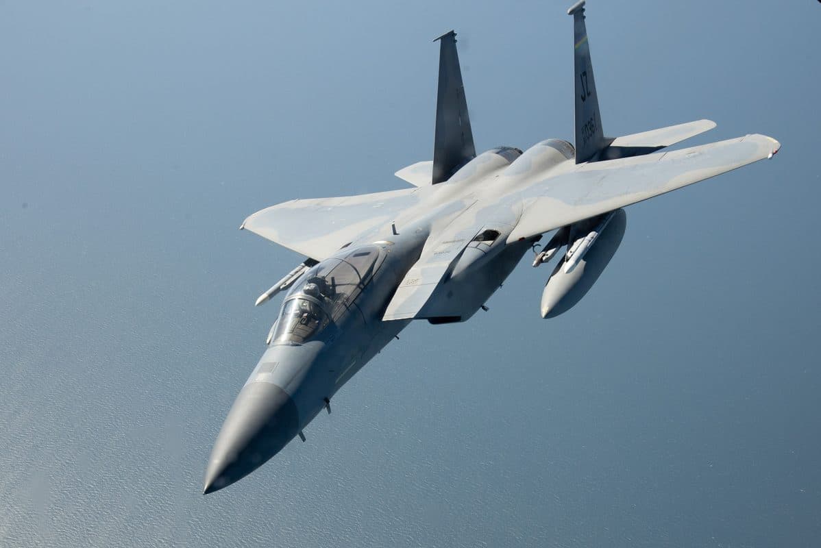 F-15E Strike Eagle in flight over coastline during combat training mission