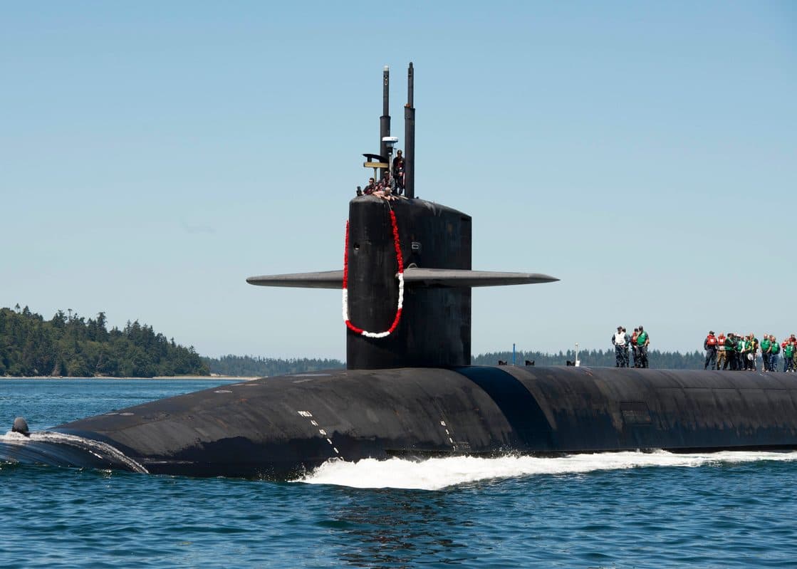 U.S. Navy submarine crew members returning to port after a strategic patrol deployment