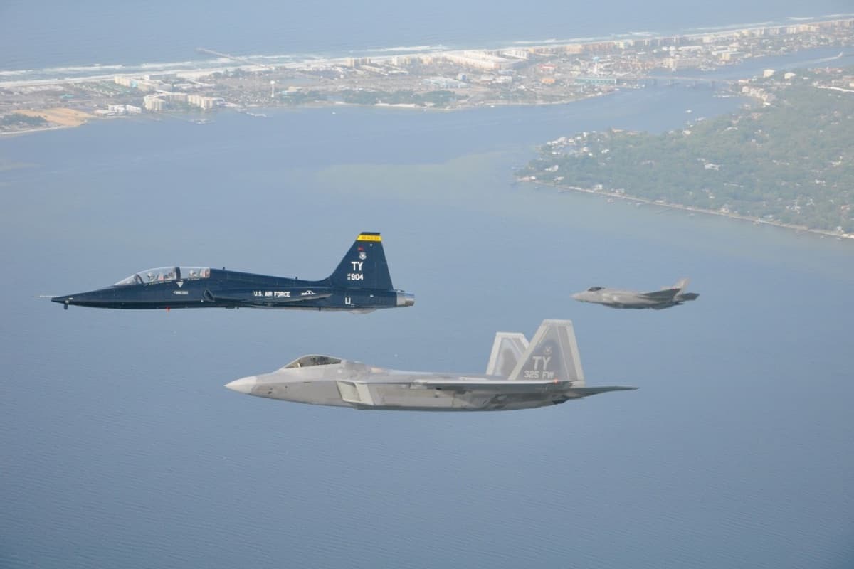 F-22 Raptor and F-35 Lightning II flying in formation over the Emerald Coast