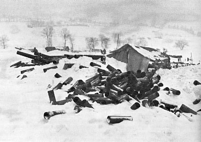 American troops and armor counterattacking through the snowy Ardennes forest, 1945