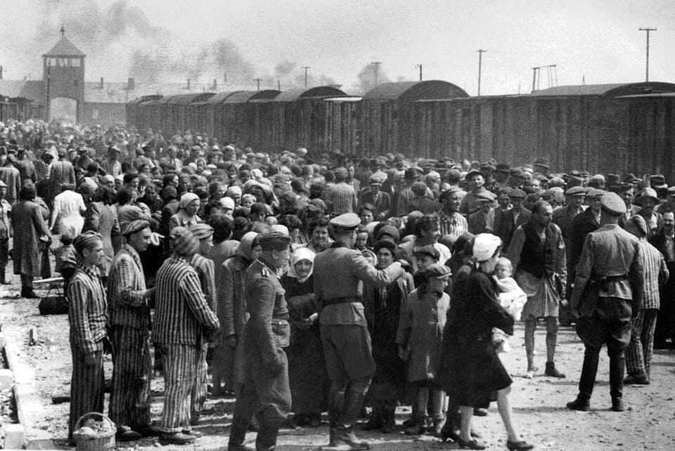 The gates of Auschwitz-Birkenau with the railway tracks leading into the camp