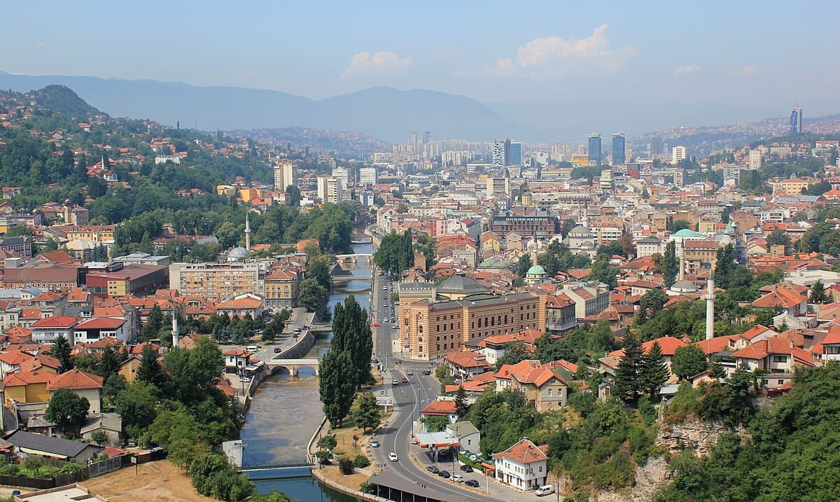 A Sarajevo resident runs across "Sniper Alley" under the threat of Bosnian Serb snipers during the siege of Sarajevo