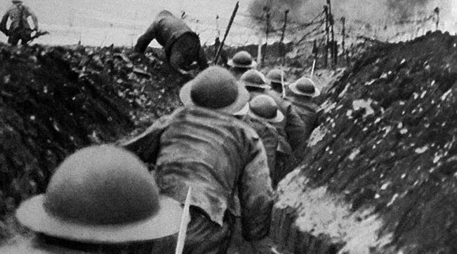 Soldiers standing in a muddy World War I trench on the Western Front