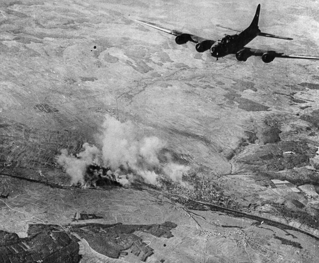 B-17 over Schweinfurt with smoke rising from the ball bearing factories below, October 1943