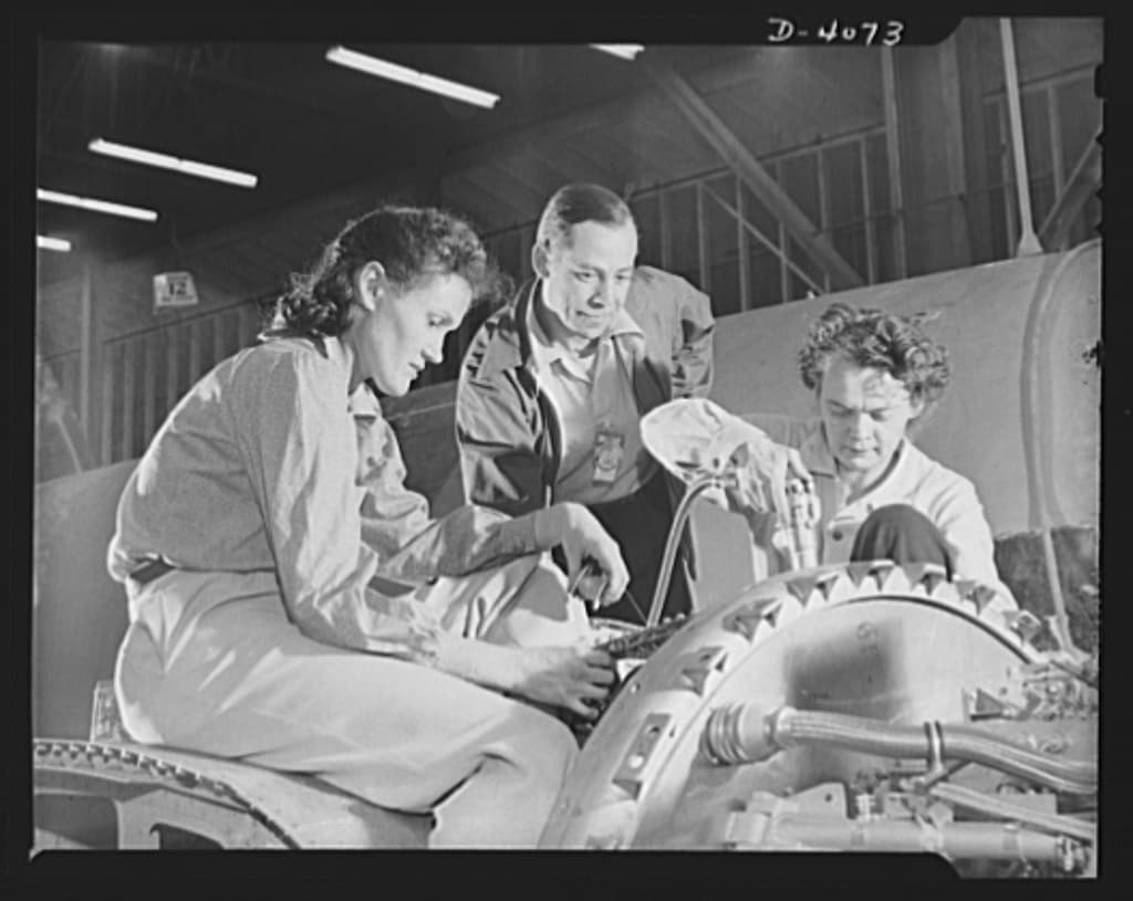 Women workers building aircraft components on a wartime factory production line