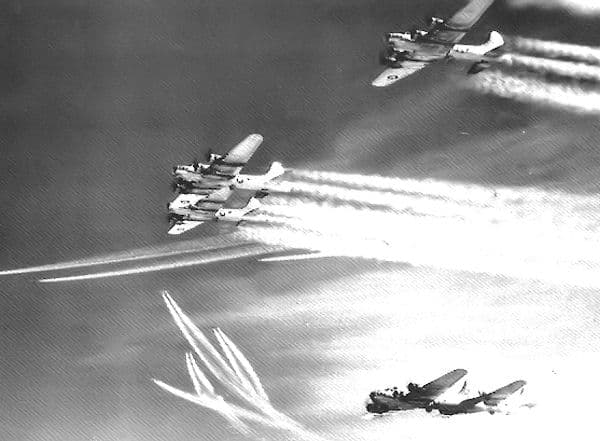 B-17 combat box formation with multiple bombers in tight defensive grouping leaving contrails