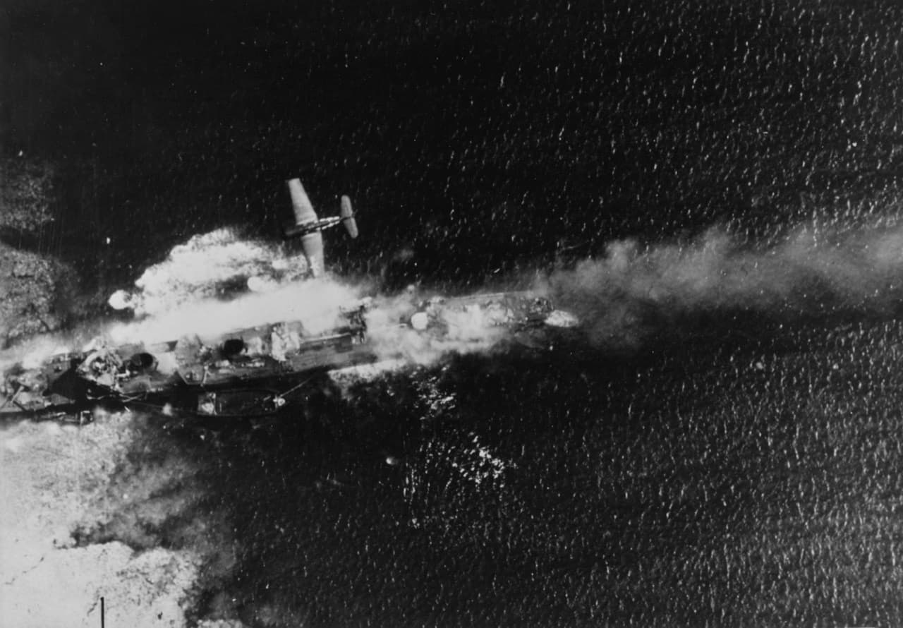 Aerial combat action over a Japanese warship in the Pacific, February 1944