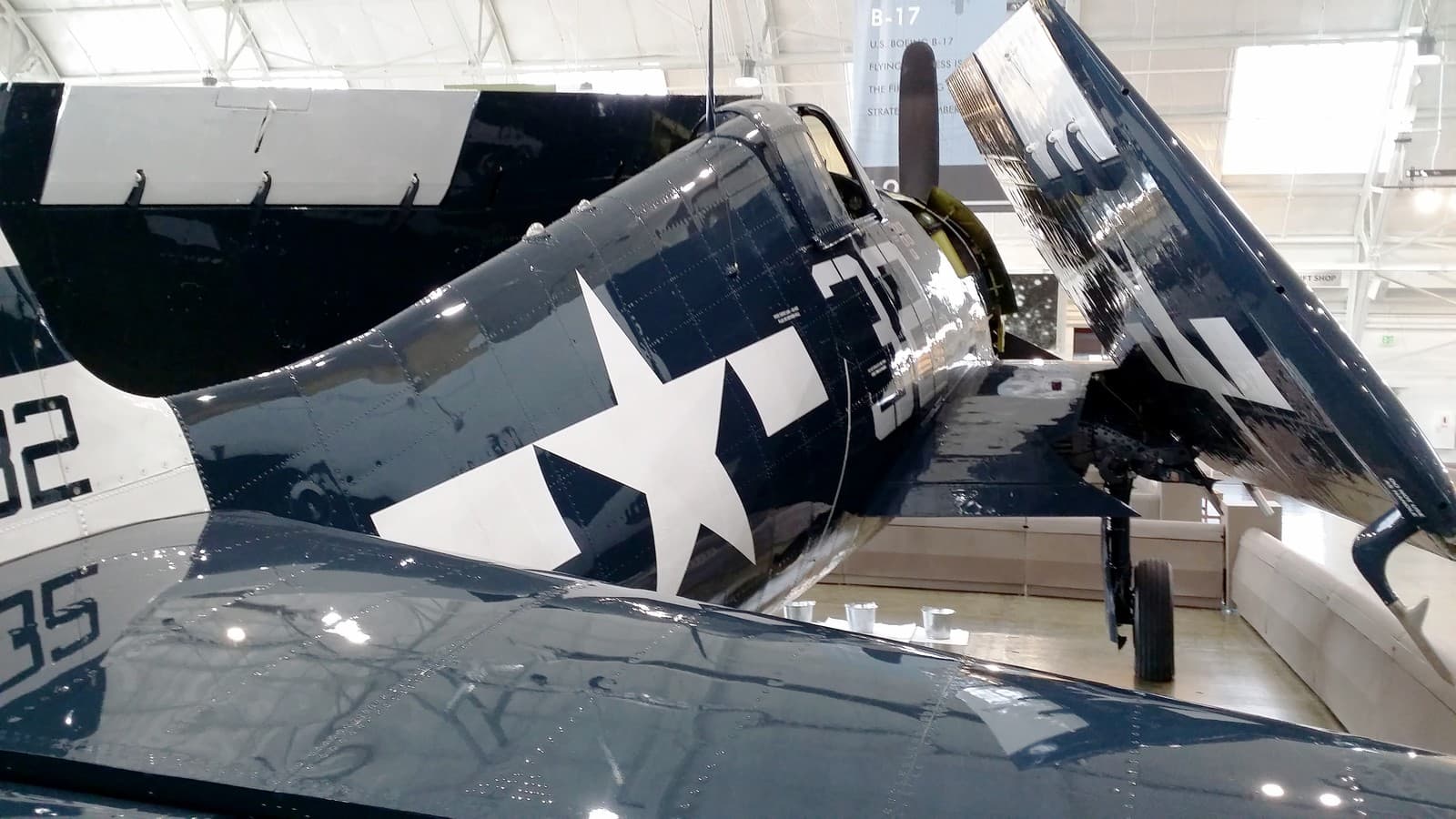 F6F Hellcat with wings folded aboard a US Navy carrier, showing the aircraft that dominated Pacific air combat from 1943