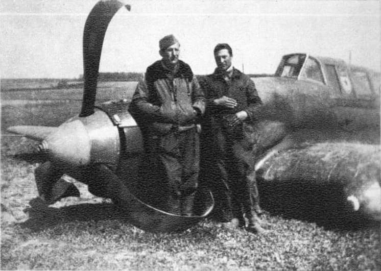Soviet pilot and gunner standing beside their Il-2 after emergency landing, April 1945
