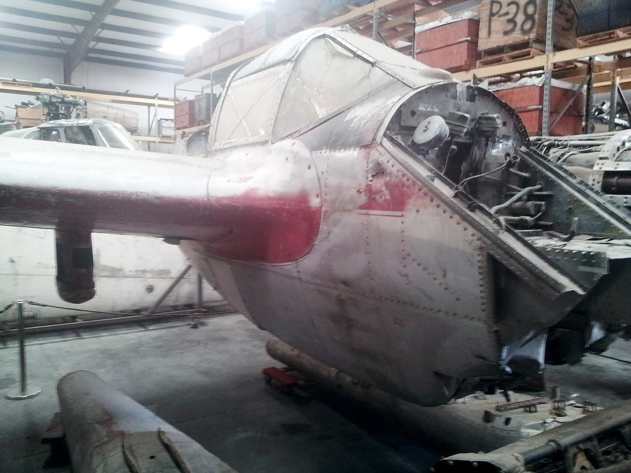 Lockheed P-38 Lightning on display at a museum, front angle showing nose armament concentration