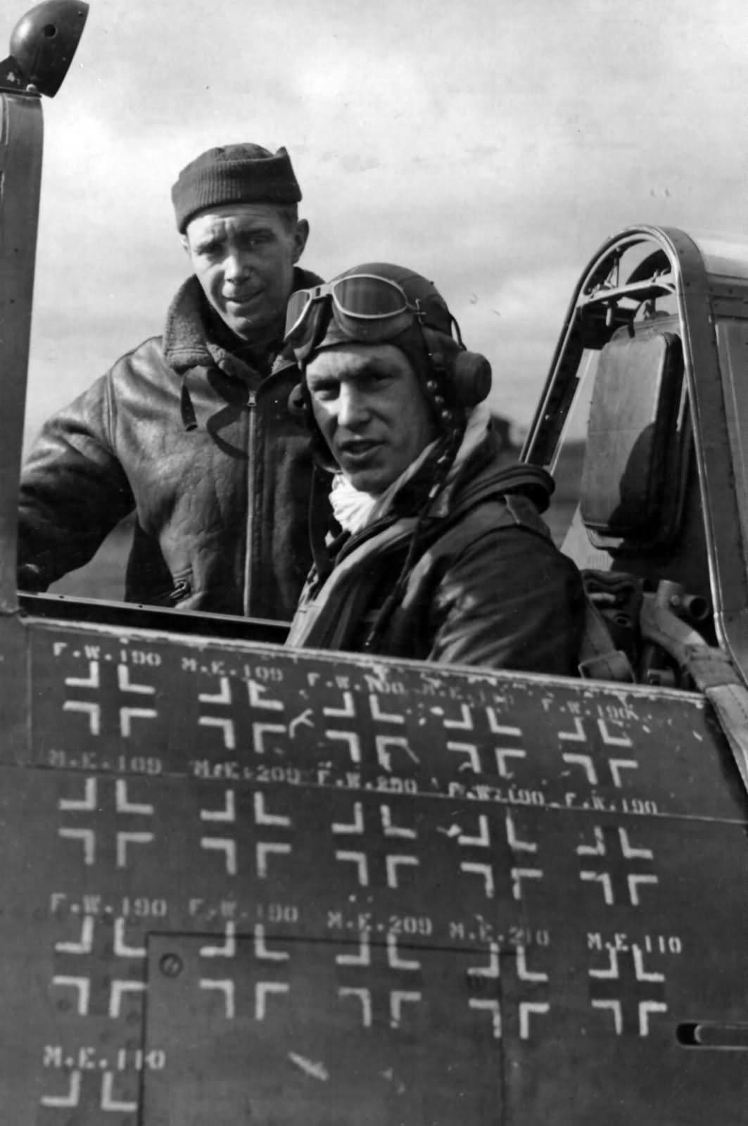 Captain Robert S. Johnson with his crew chief beside his P-47 showing kill markings, March 1944