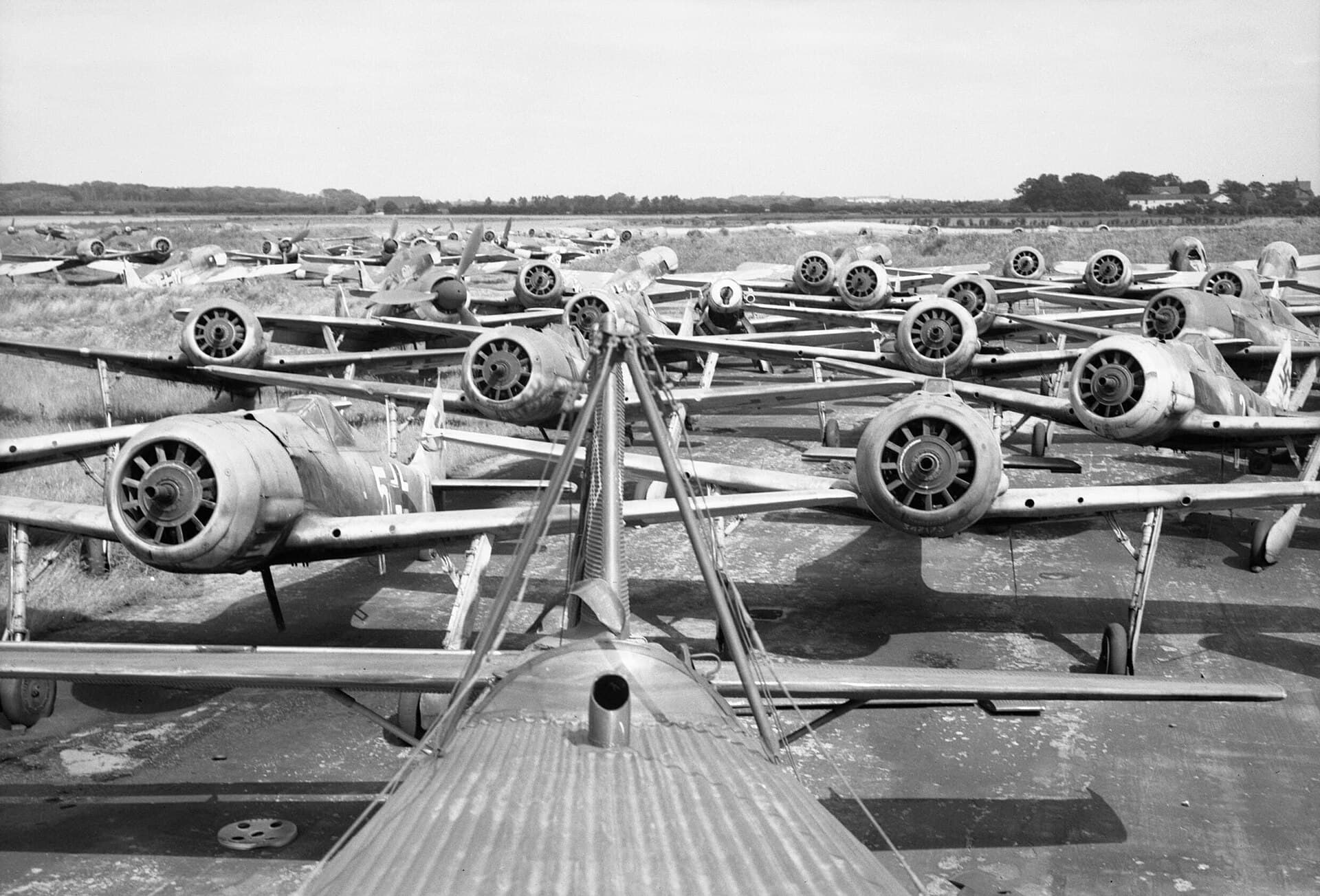 Dozens of Focke-Wulf Fw 190 fighters parked in rows at Flensburg airfield after the German surrender