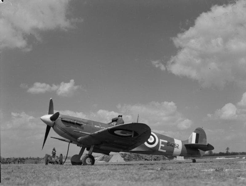 Spitfire on the ground at RAF Hornchurch with ground crew member in the cockpit