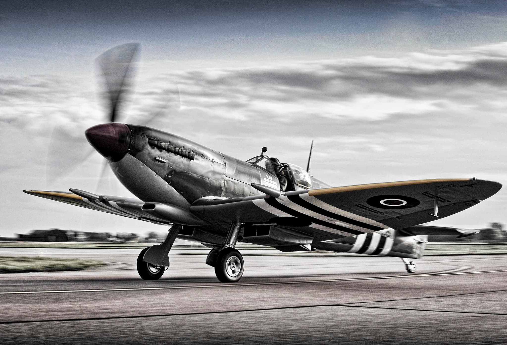 Spitfire with black and white D-Day invasion stripes clearly visible on fuselage and wings
