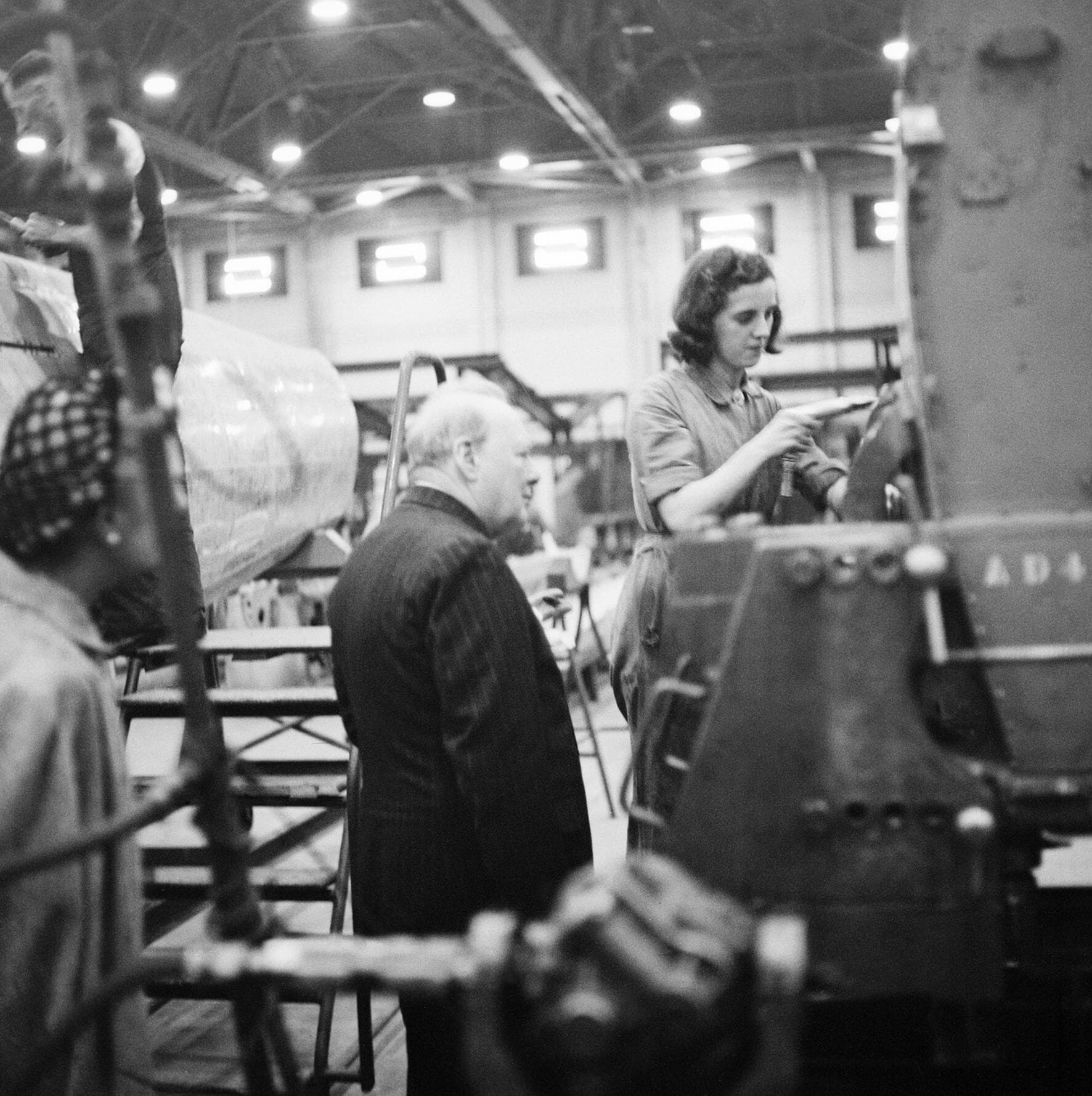 Winston Churchill watching a riveter at the Castle Bromwich Spitfire factory, September 1941