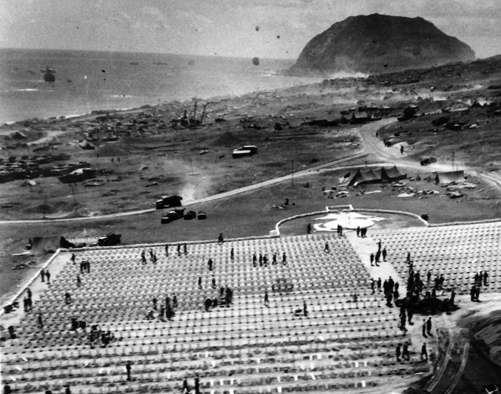 US Marines advancing across the volcanic terrain of Iwo Jima in February 1945