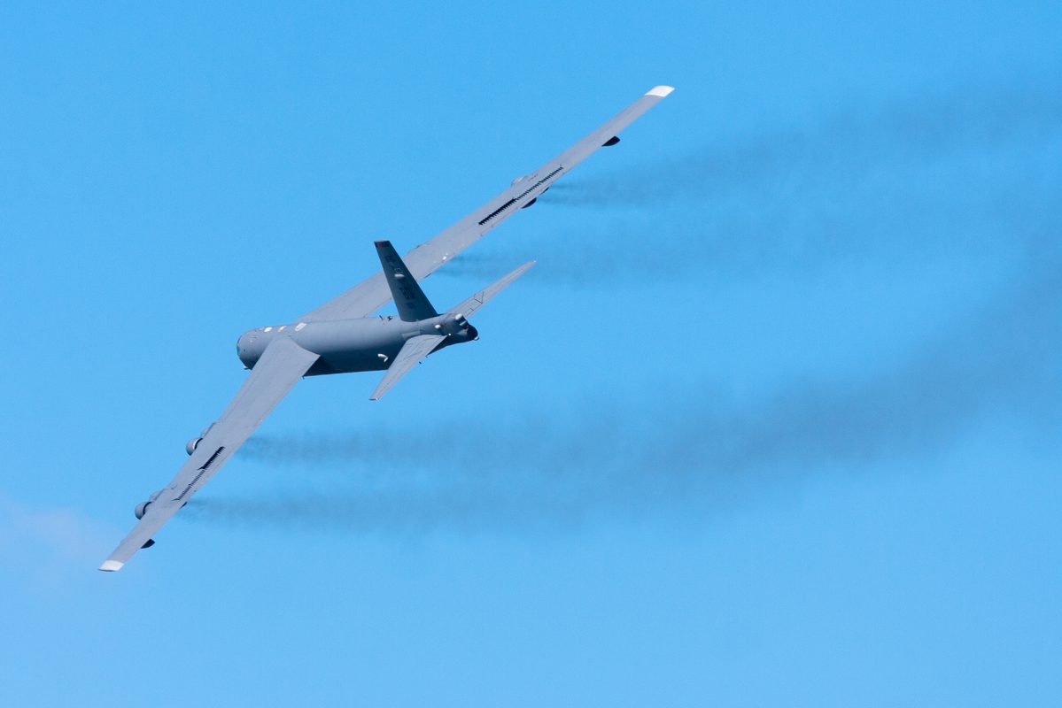 B-52 Stratofortress dropping payload over a desert landscape