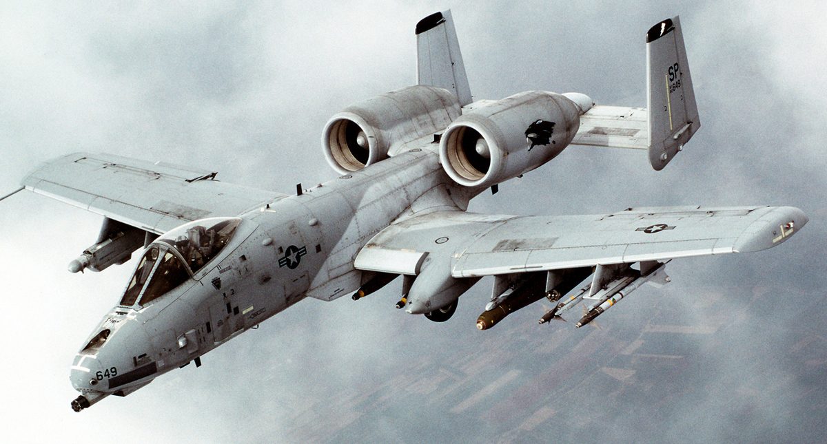 A-10 Thunderbolt II firing its GAU-8 cannon with visible muzzle flash