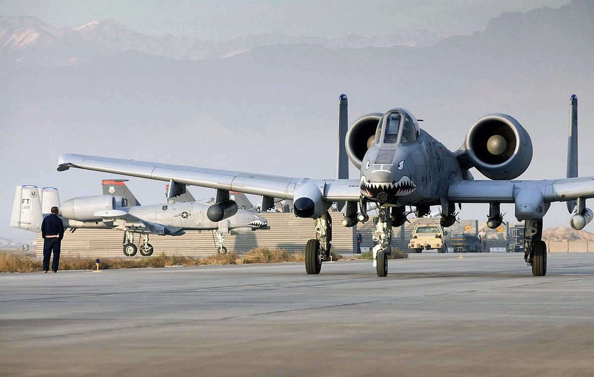 Multiple A-10 Thunderbolt II aircraft parked on a military flightline, ready for combat operations