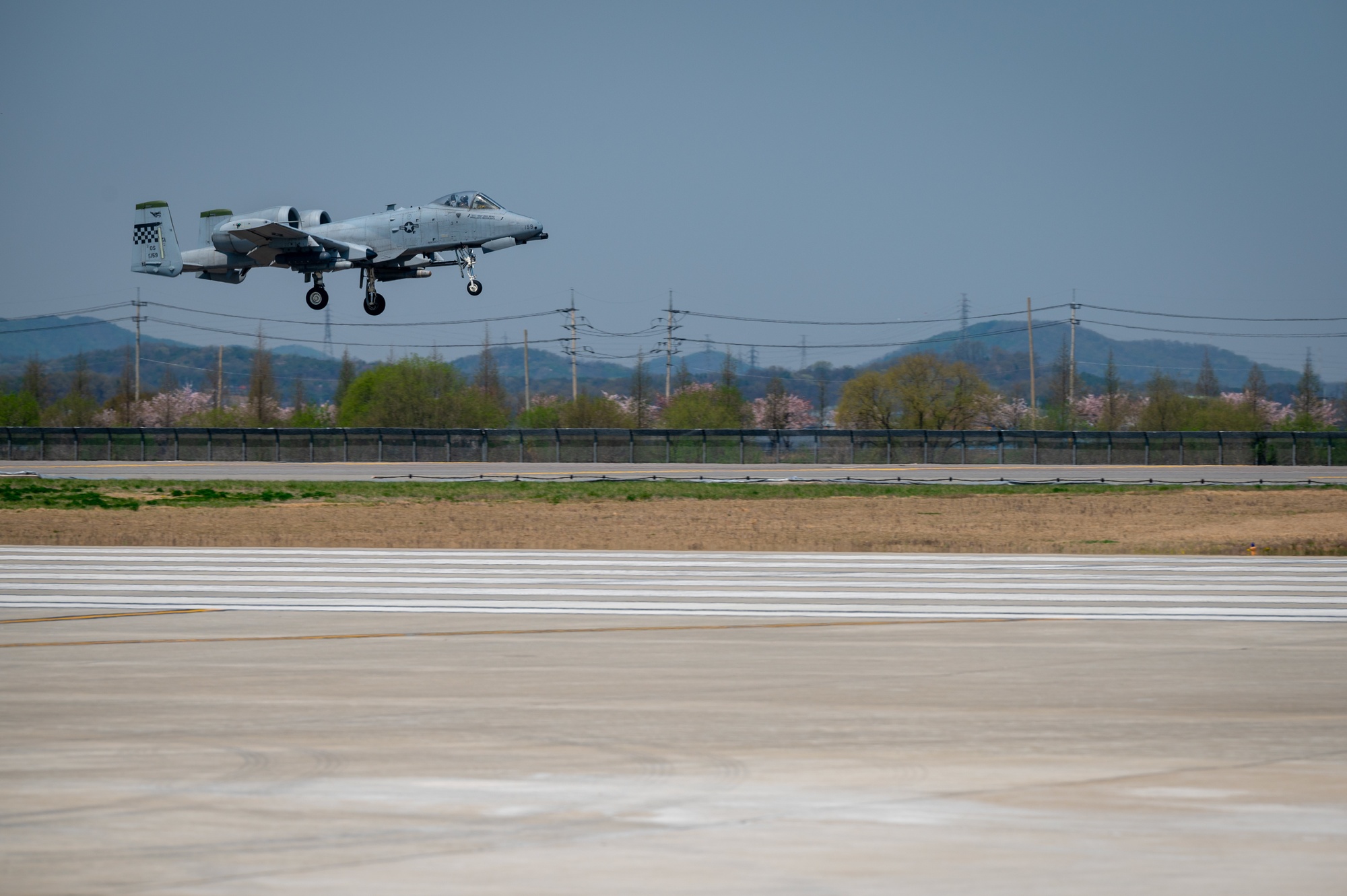 A-10 Thunderbolt II landing on the flightline, showing the distinctive twin-engine profile and nose-mounted GAU-8 cannon