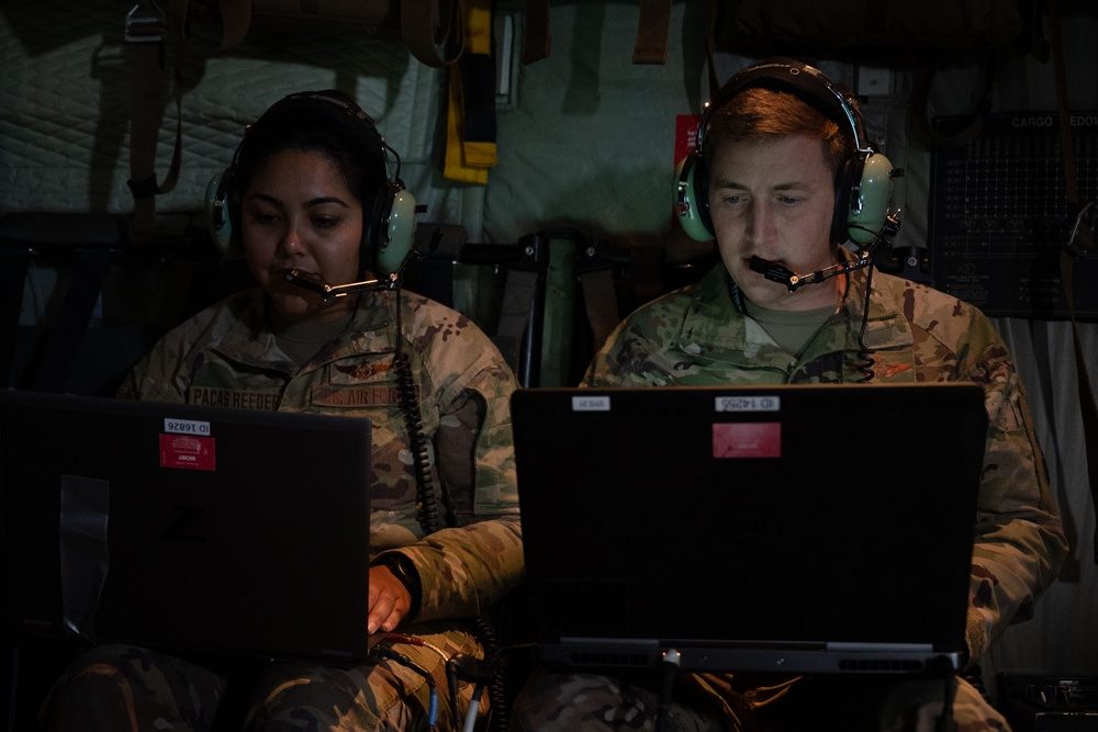 AC-130J weapons operators monitoring systems at laptop stations during a sortie